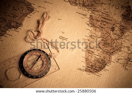 compass on old world map.