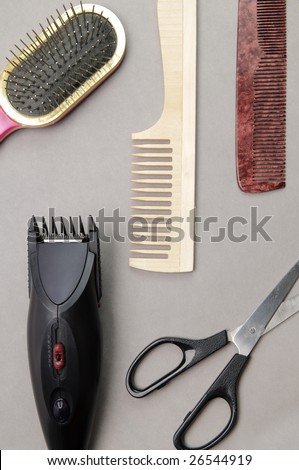 Some barber's accessories over gray background