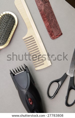 Some barber\'s accessories over gray background