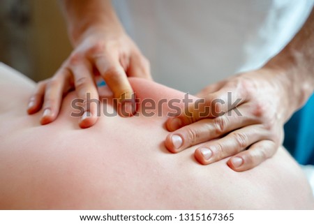 Image from above of hands of man massaging young woman.