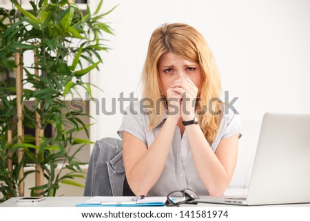 tired young woman on the laptop having some problems in the office