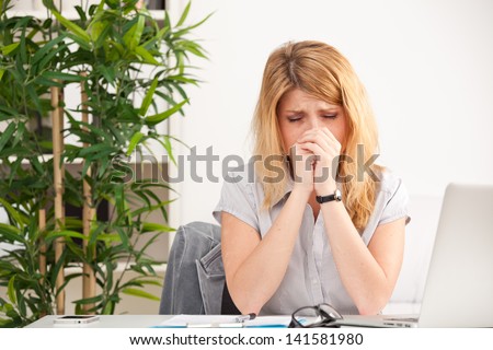 tired young woman on the laptop having some problems in the office