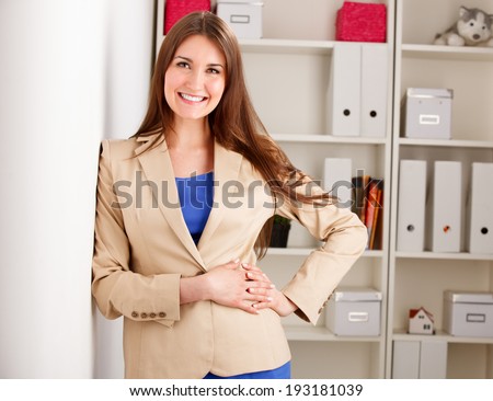 young business woman smiling in an office environment