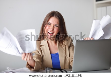 angry woman in office working with documents, laptop