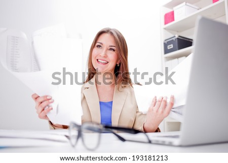 picture of worried woman with documents in office