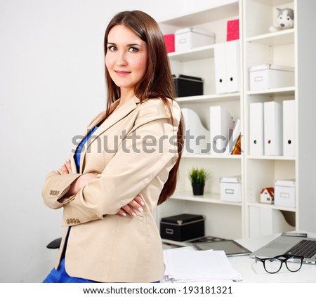 Sucessful business woman looking happy at office
