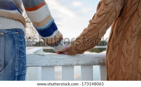Close up of mans hand holding a hand of a woman