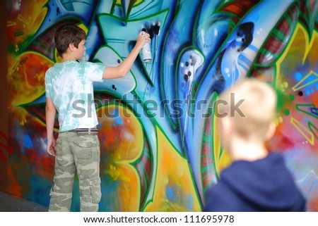 kid spraying graffiti