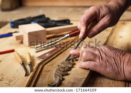 Senior carpenter restoring old furniture Senior carpenter restoring old furniture