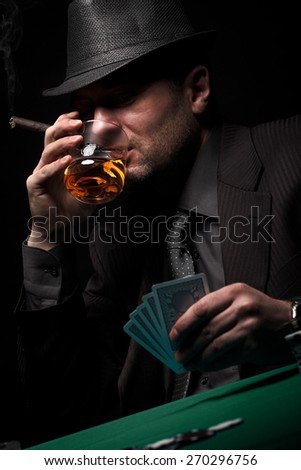 Male gambler playing poker, drinking whiskey and smokes a cigar, Dark color Intensity.