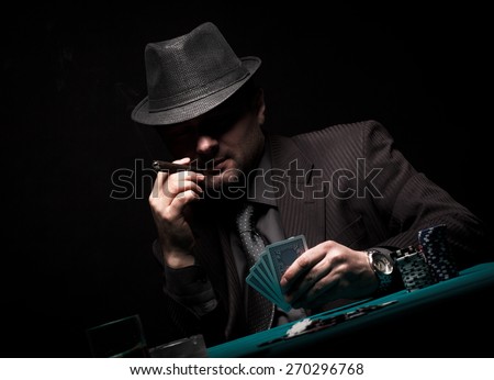 Male gambler playing poker and smokes a cigar, Dark color Intensity.