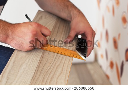 Marking the laminate with pencil and measuring tools