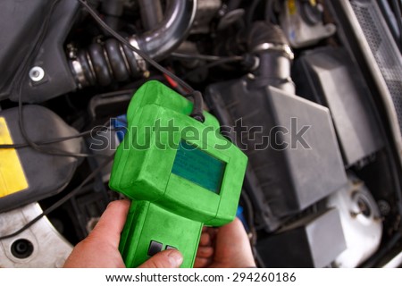 Auto mechanic testing the electrical system on automobile