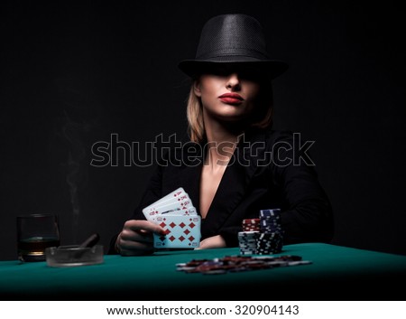 Satisfied female gambler shows royal flush in her hand. Dark color Intensity.