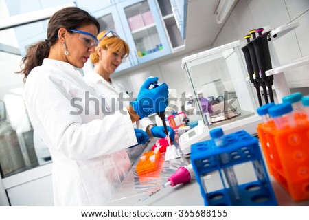 Photo of real female scientists researching in laboratory.