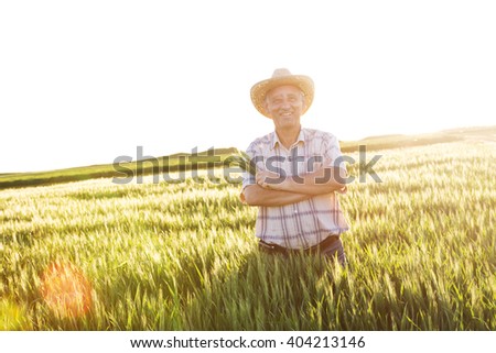 Portrait of farmer standing in a wheat field