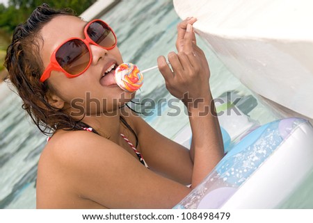 Young woman on air bed in the pool