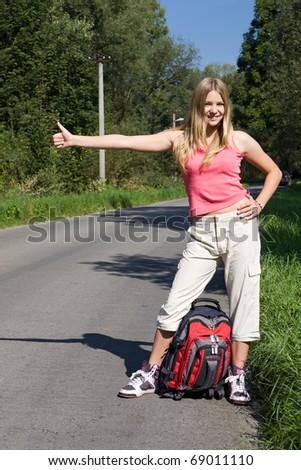girl with rucksack stops the car