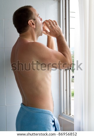 Screaming man wrapped towel in bathroom