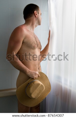 hidden man looking out window in bathroom
