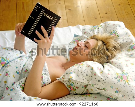 Woman read Bible in bed
