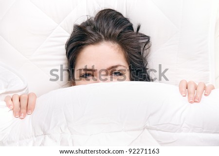 girl hides her face in bed