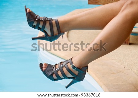 female legs over blue water