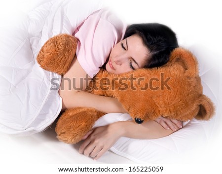 girl sleeping with teddy bear in bed