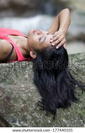 woman lying on a rock