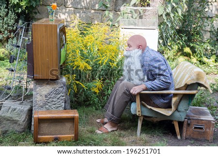 TV fans sitting outside with TV
