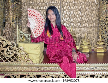 Asian woman sitting in the throne room