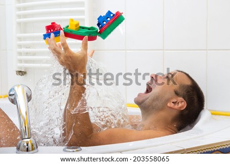 man playing in the bath with steamer