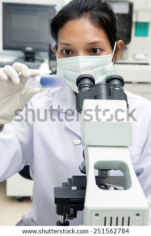 Woman working with a microscope in Laboratory