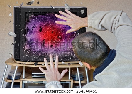 man in front of a television screen exploding