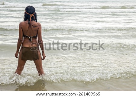 Native woman standing in the sea