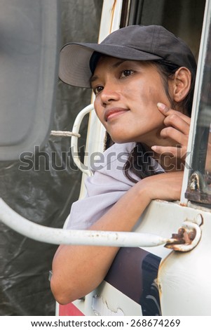 A woman driver watching her face in the mirror