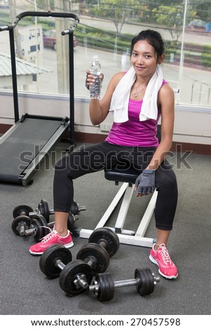 woman with drink in the gym