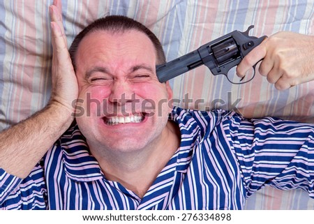 man in pajamas with a gun