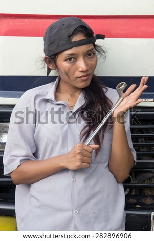 service-woman stands in front of truck