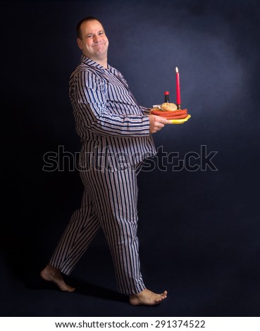 Obese man carries a tray of food