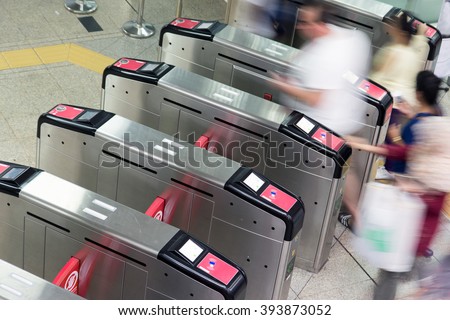 People going through the turnstile in the subway. Passengers in the subway. Tourists walk in the turnstile railway station. Metro station turnstiles. Entrance to the metro station turnstiles.