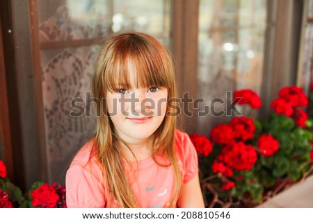 Cute little girl hiding from the heat in a shadow