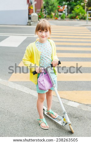 Pretty little girl is going to cross the road alone