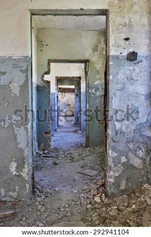 Ruins of a huge empty factory building, abandoned door