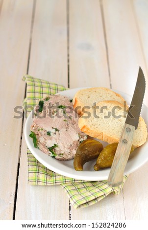 Slices of pork and parsley terrine with bread and pickles