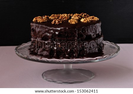 Turtle Cake, whole chocolate and caramel layer cake on a cake stand