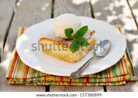 A piece of Caramel Apple Sponge Bake (Pudding) with a Banana Ice Cream Scoop