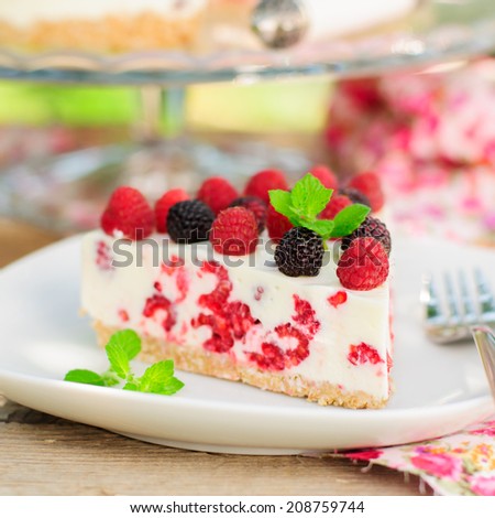 A Piece of No-bake Fresh Raspberry Cheesecake with Red and Black Raspberries and Melissa, Summer Cake, square, close up