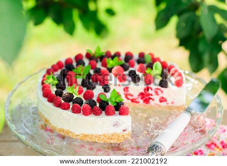 No-bake Fresh Raspberry Cheesecake with Red and Black Raspberries and Melissa, Summer Cake, copy space for your text