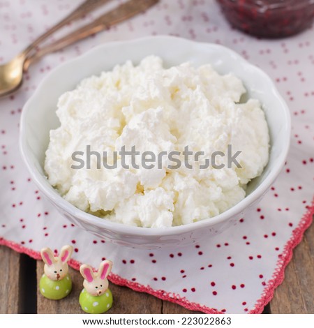 Homemade Cottage Cheese (Quark, Cream Cheese, Curd) in a White Bowl with Raspberry Jam, Healthy Breakfast, square